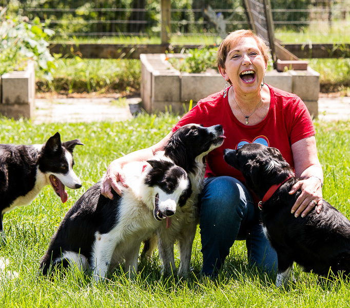 Kathy with dogs by garden laugh